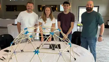 MBA students during a Team Development Day in Ireland, working together on the Domeworks activity to build a geodesic dome and strengthen collaboration skills.
