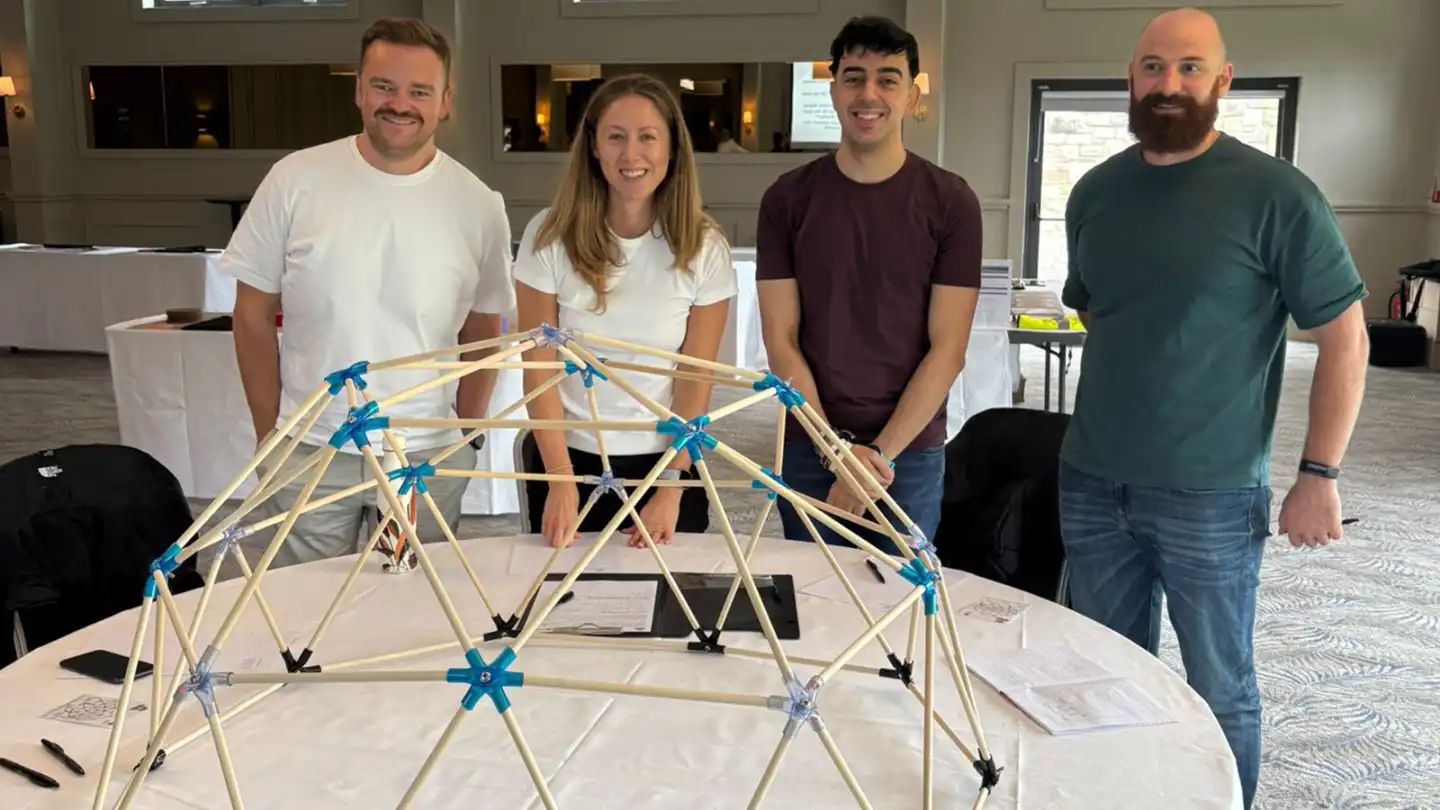 MBA students during a Team Development Day in Ireland, working together on the Domeworks activity to build a geodesic dome and strengthen collaboration skills.