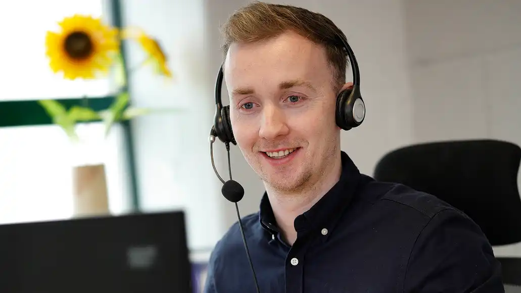 Team building host smiling while engaging virtual event participants