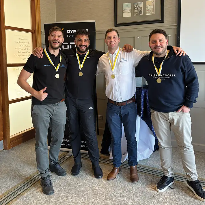 Senior leadership team celebrating Code Breaker challenge win at corporate team building event in Druids Glen