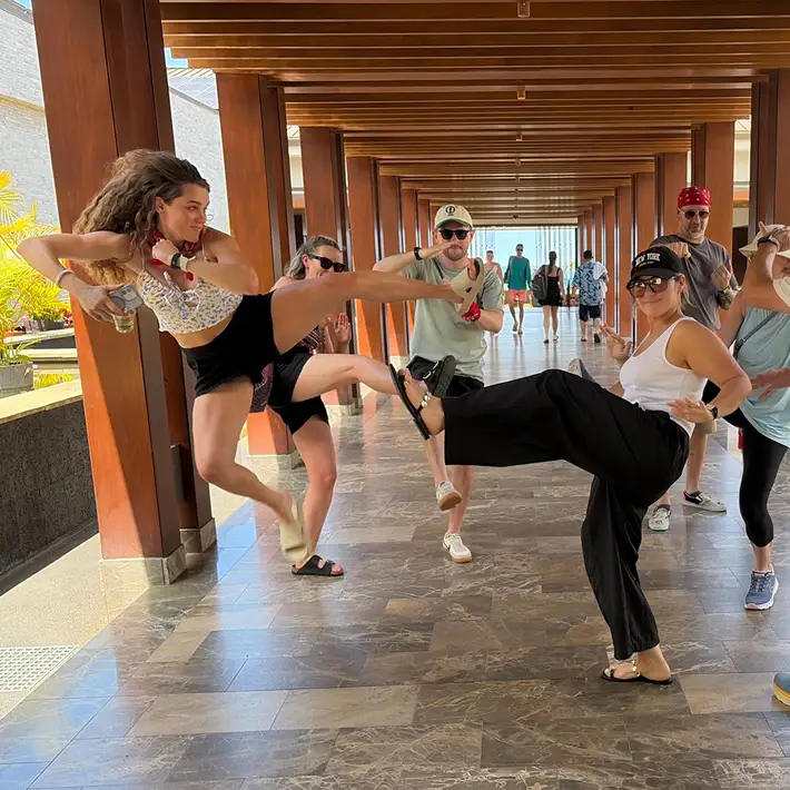 Participants doing action pose for team building challenge at Andaz Maui resort Hawaii
