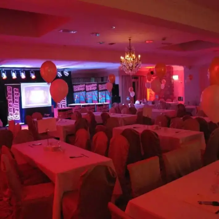 Gameshow Challenge set with podiums, lighting, and large screen