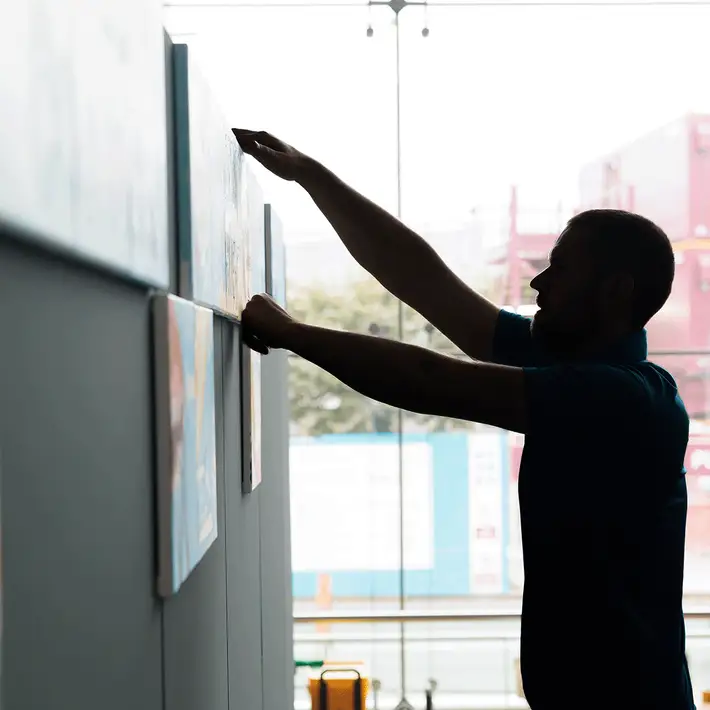 Dynamic Events facilitator assembling Big Picture team building artwork panels during Coca-Cola’s 50th anniversary event in Ireland.