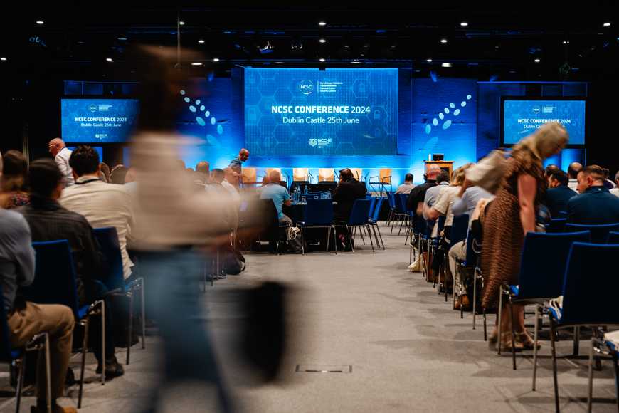NCSC conference with people getting their seats and listening to the opening lines