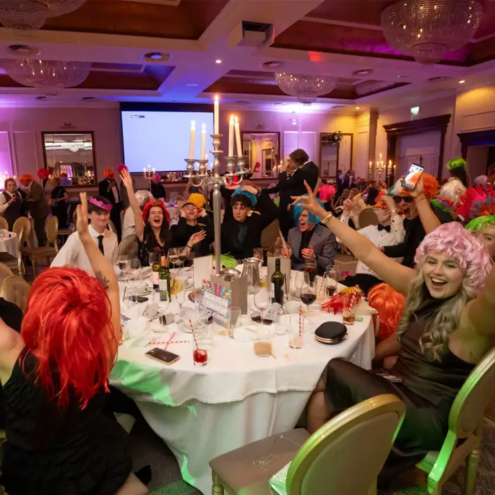 happy young team doing disco bingo indoor team building