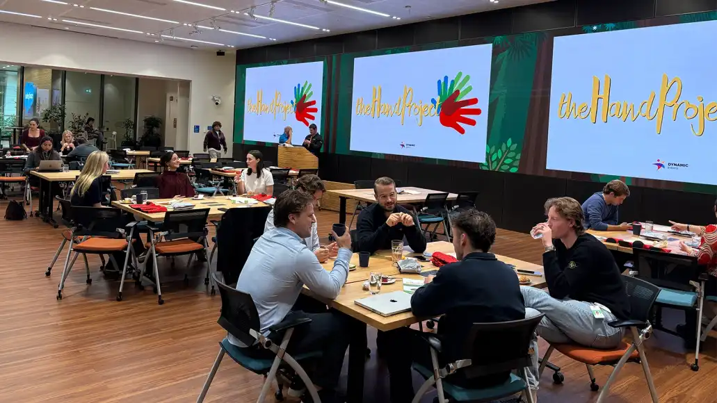 Public sector team building activity indoors featuring participants taking part in The Hand Project CSR workshop in Dublin.