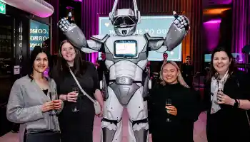 Corporate anniversary celebration with stage lighting and guests enjoying live entertainment