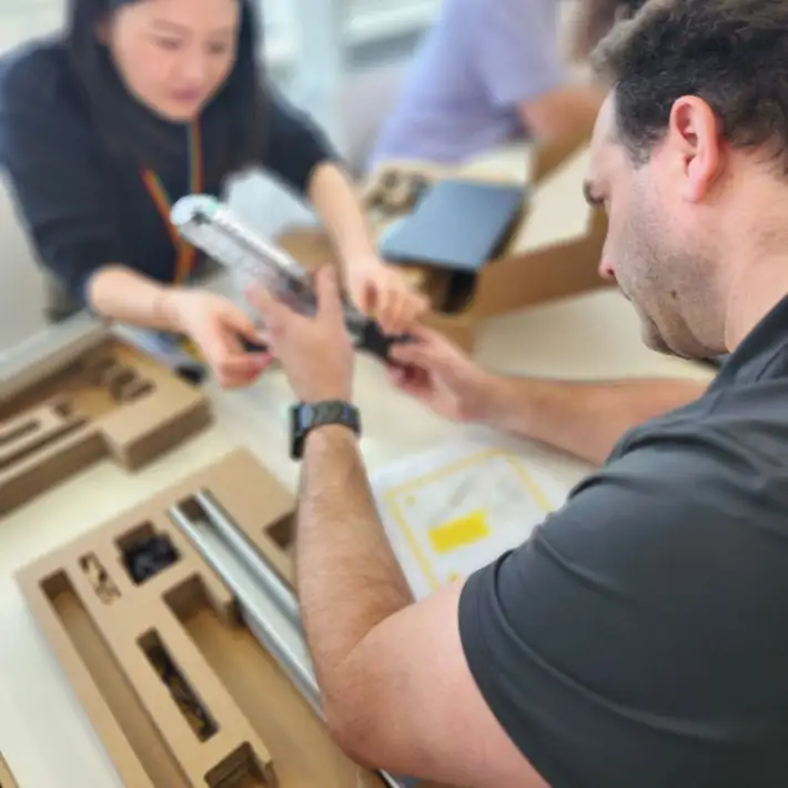 2 people making a EcoBuddy light