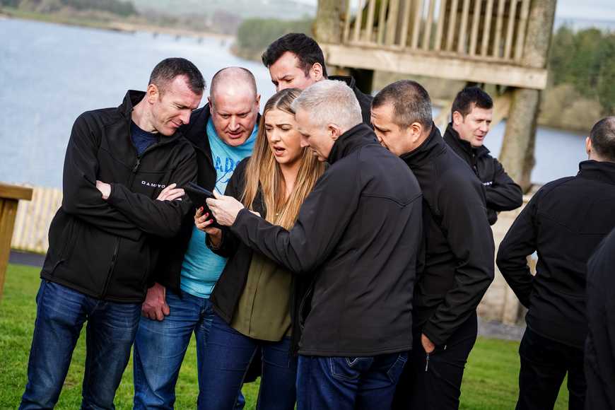 happy team doing digital treasure hunt as part of their kick off event