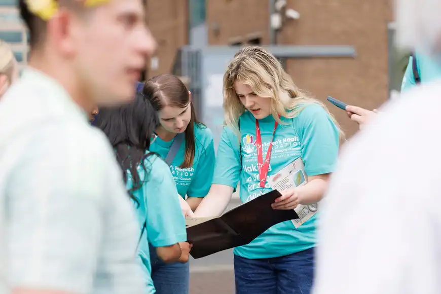 Team analysing maps and notes during a problem solving challenge for workplace team building in Ireland