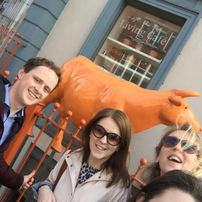 posing with a cow