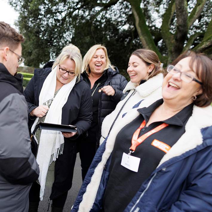 team laughing doing treasure hunt