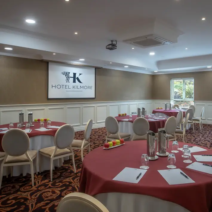 Meeting room with round table setup and presentation screen at Hotel Kilmore in Cavan