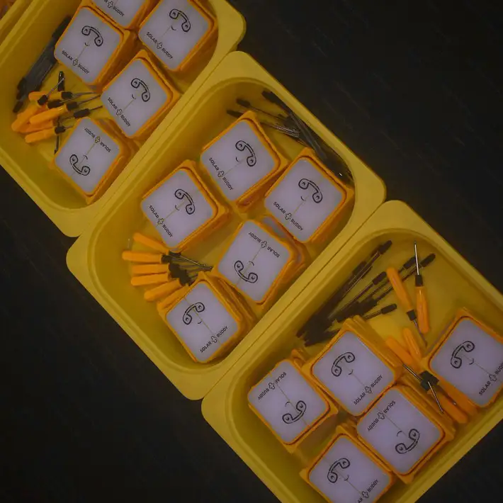 SolarBuddy kits packed in yellow trays, ready for participants to build and donate.