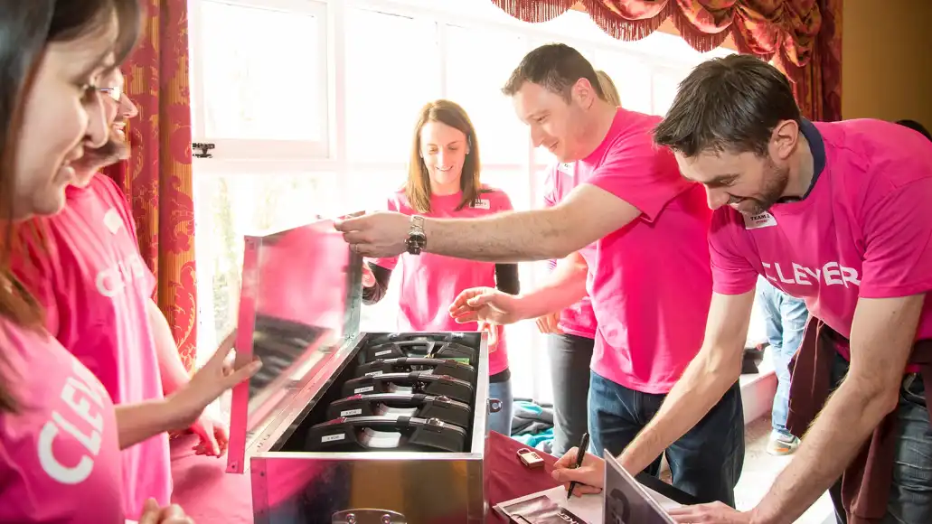 Public sector team in Ireland solving Codebreaker team building challenge indoors as part of a collaborative activity