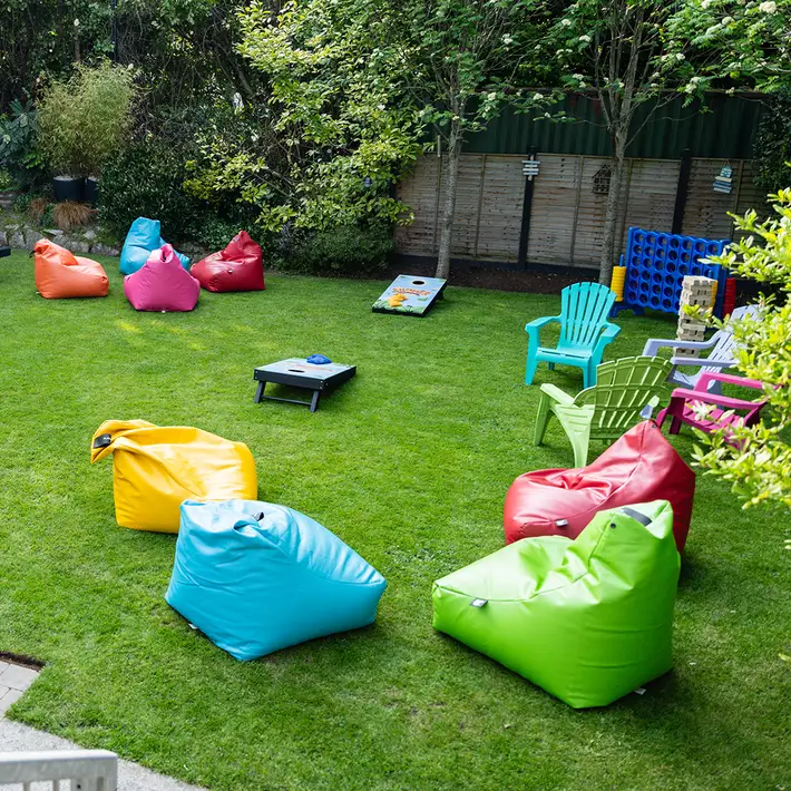 Corporate team-building area at The Sandymount Hotel, featuring bean bags, lawn games, and outdoor seating for casual networking and social events.
