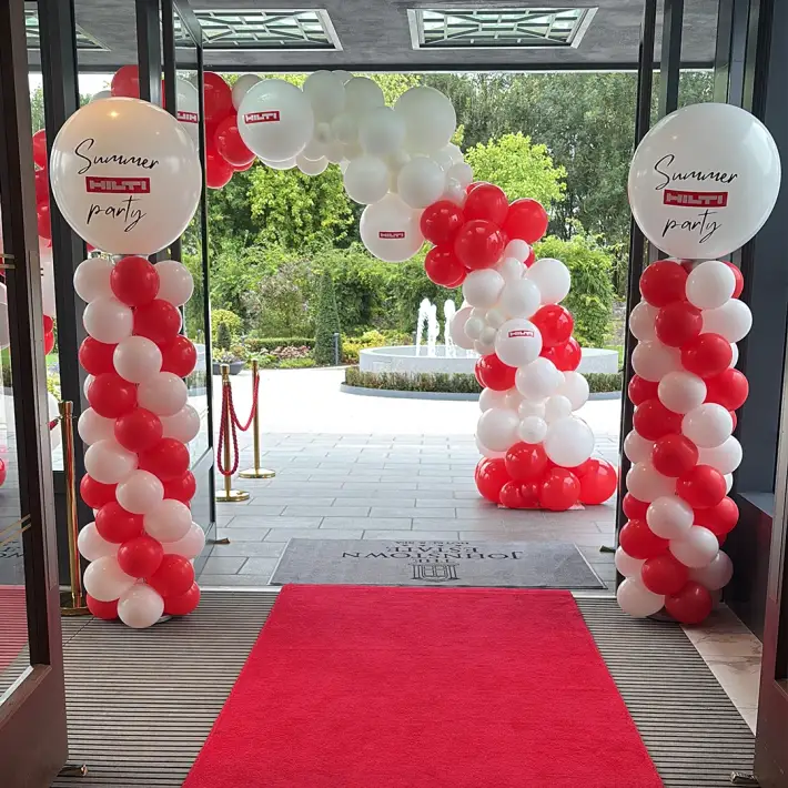 Hilti Summer Party 2025 entrance with branded balloon arch and red carpet at The Johnstown Estate corporate event