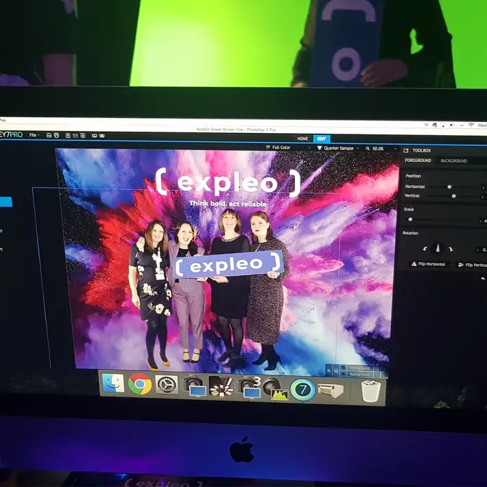 Guests posing at a branded green screen photo station during a corporate rebrand launch event in Dublin, Ireland.