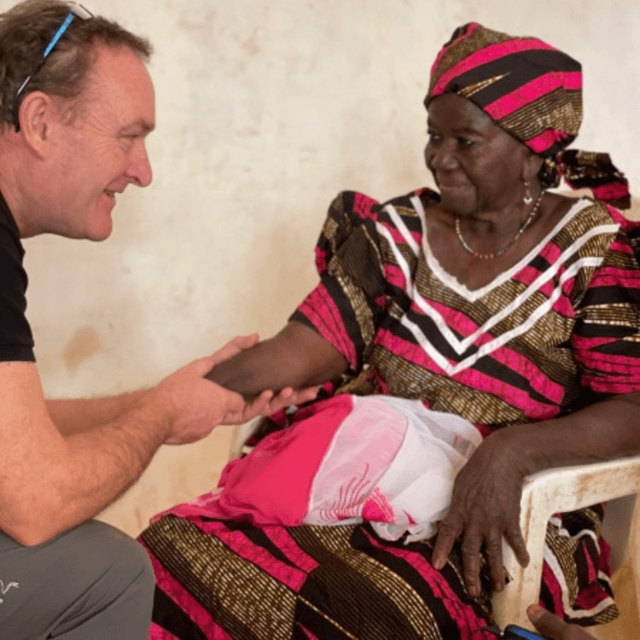 Chris shaking hands with a woman 