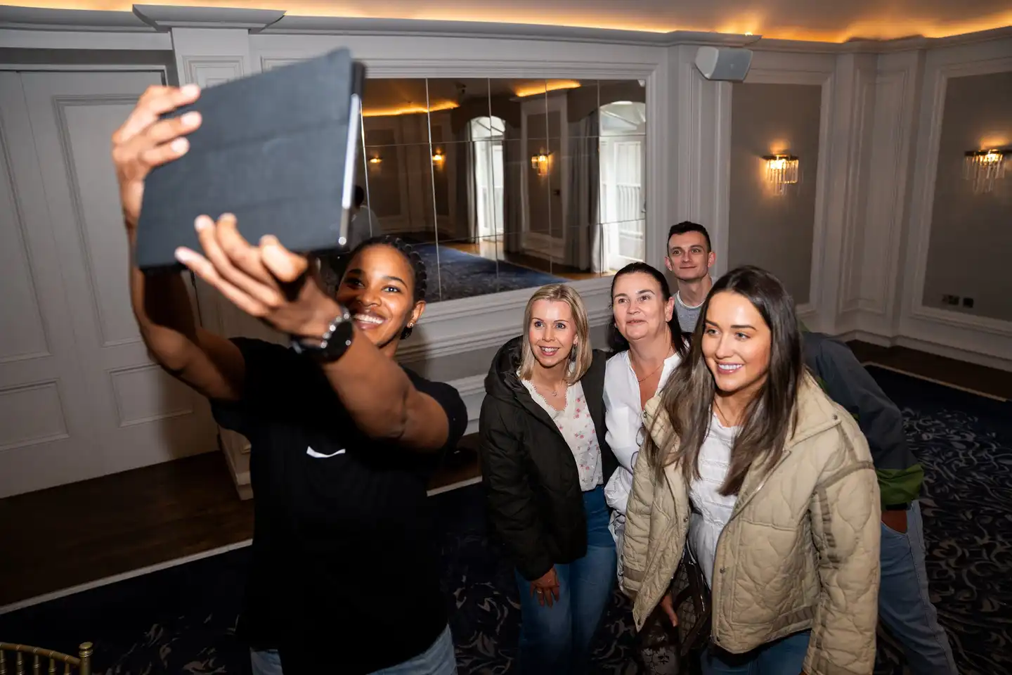 Group of new hires smiling and working together during an outdoor onboarding team-building activity in Ireland.