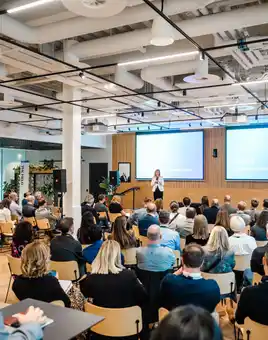 Corporate presentation event at Qualtrics Dublin office, with a speaker addressing employees in a professionally equipped event space.