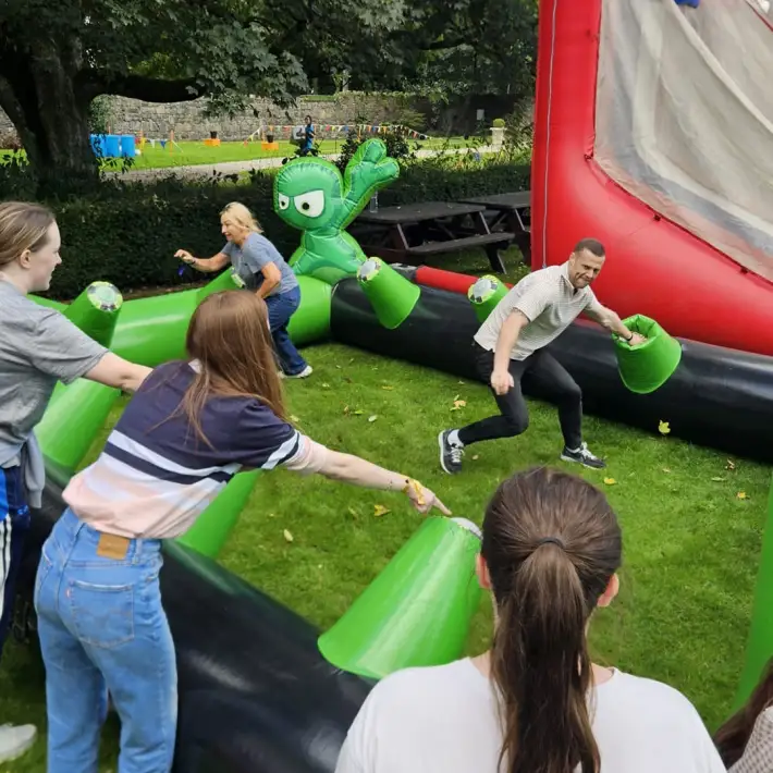 Resmed PEI employees competing in an inflatable team challenge during their outdoor Team Olympics event at The Johnstown Estate, Co. Meath.