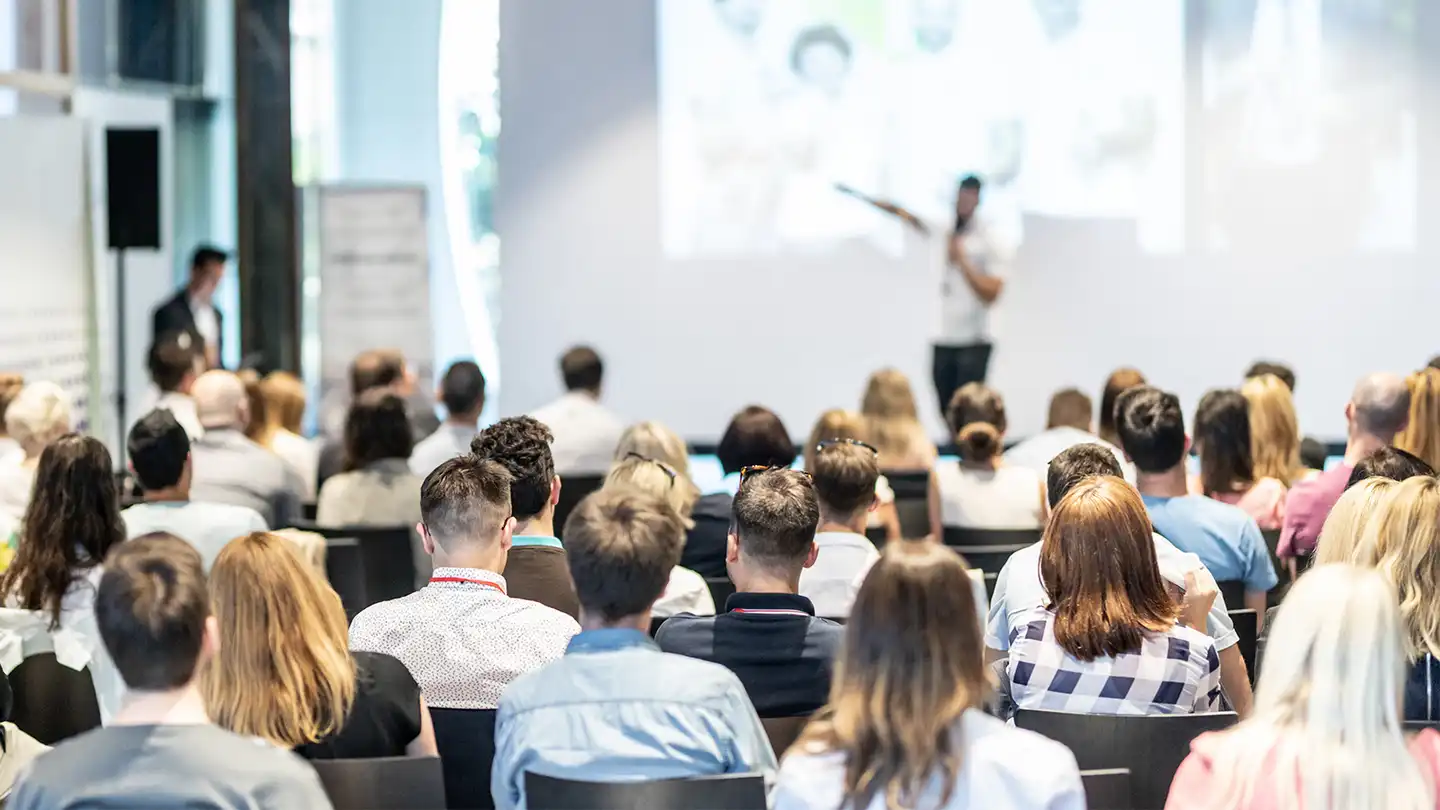Large corporate kick off conference in Ireland with keynote speaker, branded staging, and professional event setup by Dynamic Events.
