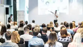 Large corporate kick off conference in Ireland with keynote speaker, branded staging, and professional event setup by Dynamic Events.