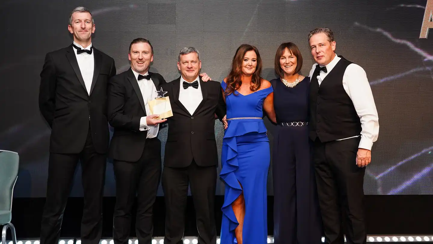 Guests celebrating at a corporate gala dinner and awards night in Ireland with live entertainment and elegant event styling