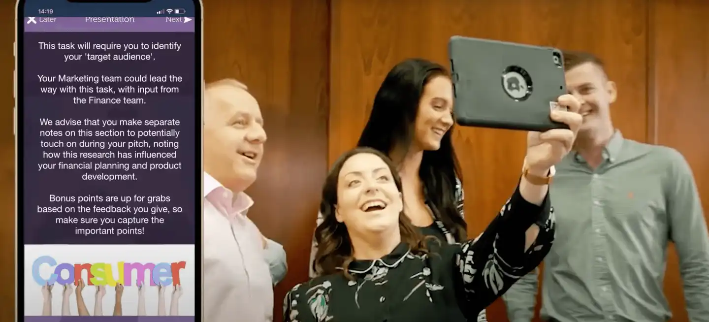 Team presenting their target audience analysis during The Pitch business simulation activity, with app-based tasks