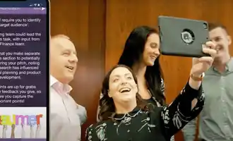 Team presenting their target audience analysis during The Pitch business simulation activity, with app-based tasks