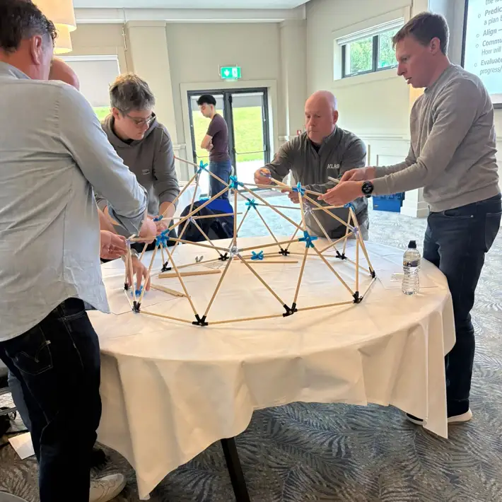 MBA students in Ireland collaborating on the Domeworks activity, building a geodesic dome to strengthen teamwork, problem-solving and communication skills.