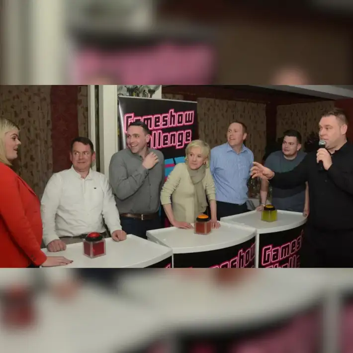 Team member playing a prize round at the front of the room