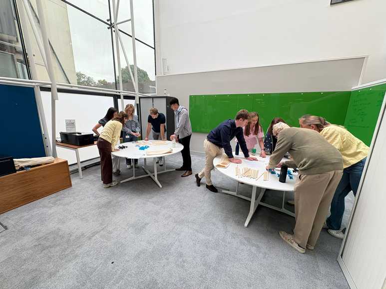 Corporate team training workshop in Ireland with employees collaborating on hands on activities to build problem solving and teamwork skills