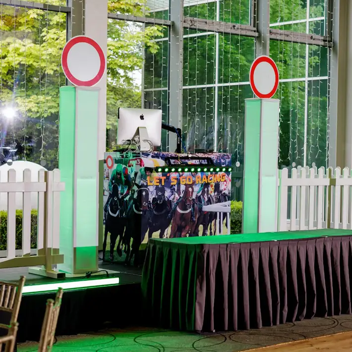 Corporate Race Night stage setup with racing themed décor and MC booth