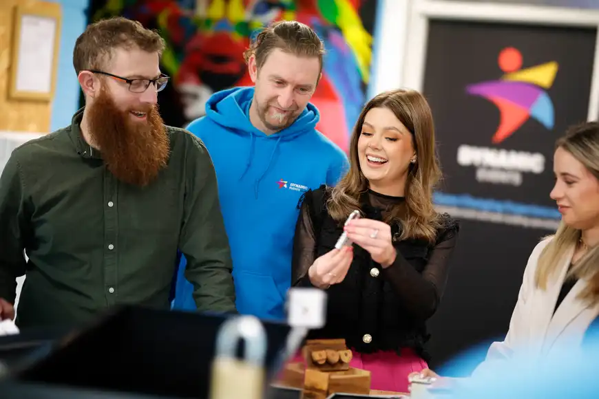 College staff team solving a challenge with a lock during the Code Breaker team building activity in Ireland.
