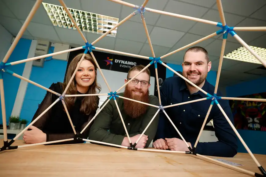 Dynamic Events managers posing for a professional photo through a dome works dome | Team Training Cork