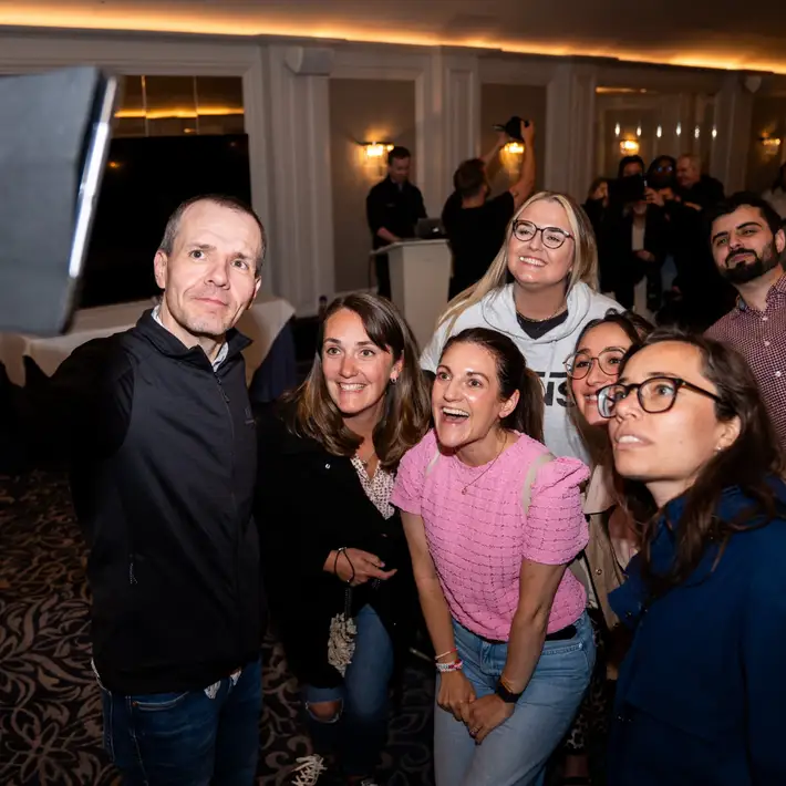 Team taking group selfie together on a ipad 