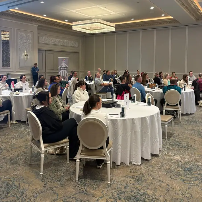 Resmed PEI employees seated at round tables during the Detour business simulation training session at The Johnstown Estate.