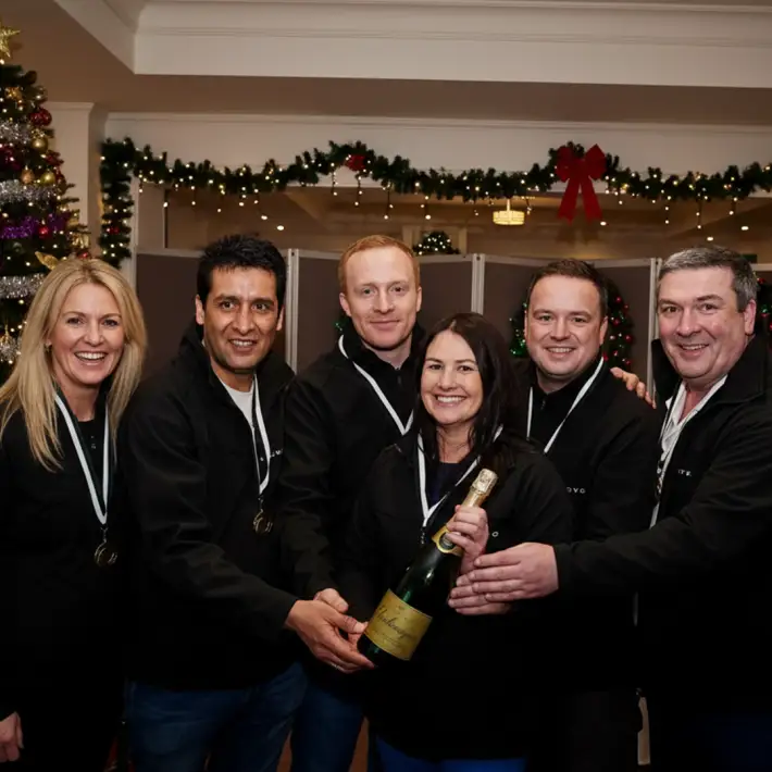 Winning team celebrating with champagne after a corporate Christmas treasure hunt in Ireland