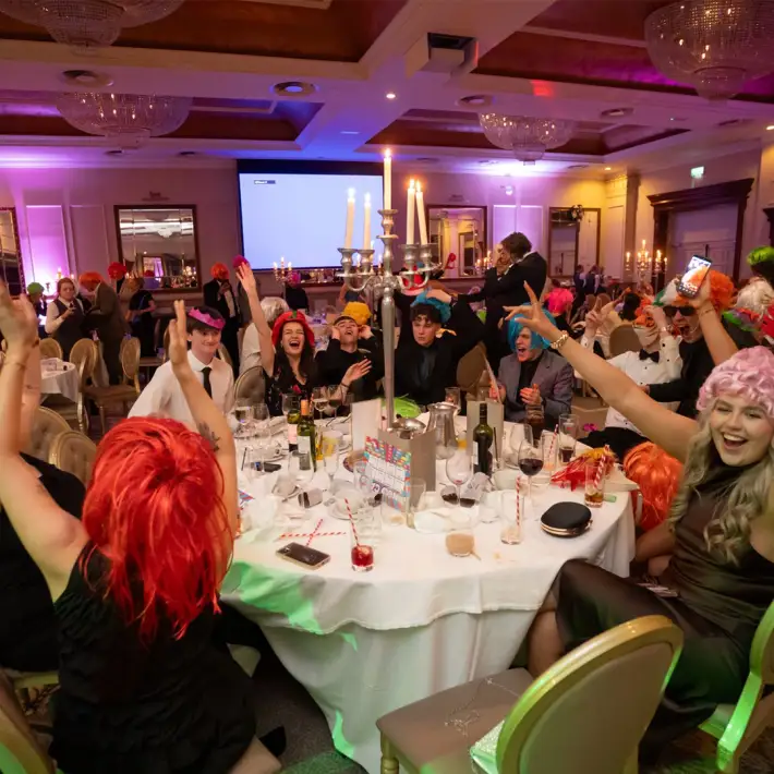 happy young people taking part in disco bingo