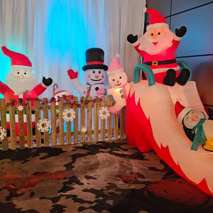 Santa decorations behind picket fence 