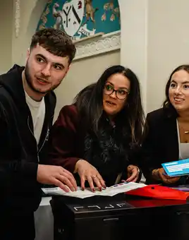 team doing indoor team building activity in ireland as part of their kick off event