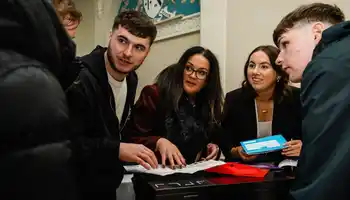 team doing indoor team building activity in ireland as part of their kick off event