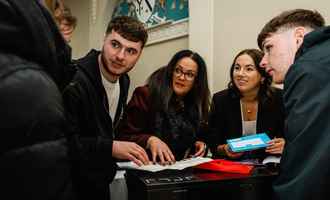 team doing indoor team building activity in ireland as part of their kick off event