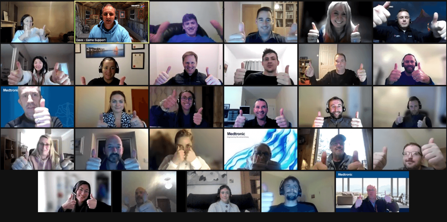 Corporate team giving thumbs up during virtual team building activity on Zoom