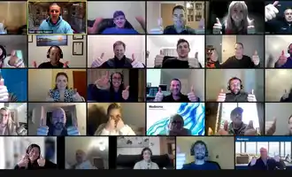 Corporate team giving thumbs up during virtual team building activity on Zoom