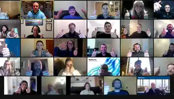 Corporate team giving thumbs up during virtual team building activity on Zoom