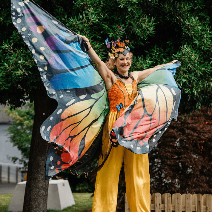 Butterfly Stilt walkers posing for a picture at corporate festival