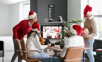 Corporate team enjoying a hybrid virtual Christmas party with festive decorations